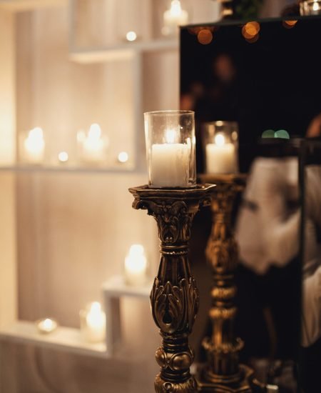 Candle shines in a bronze candleholder